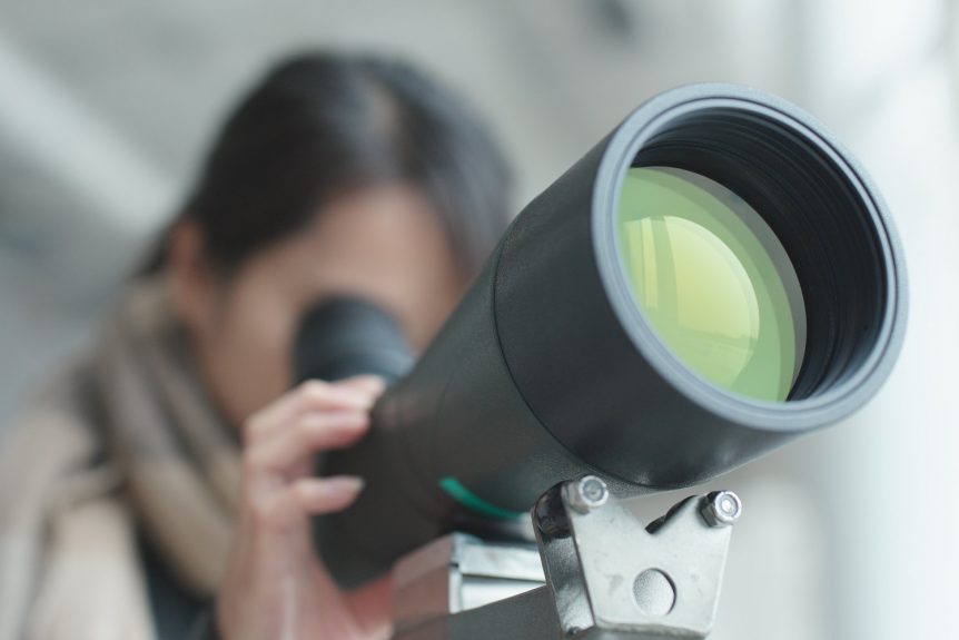 Woman looking though the telescope